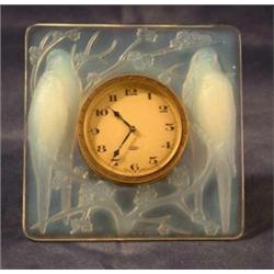 A Lalique opalescent easel clock decorated with budgerigars, moulded R.Lalique in capitals, and f...