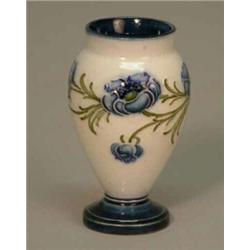 A small Moorcroft MacIntyre baluster vase, decorated with blue poppies, signed with green initial...
