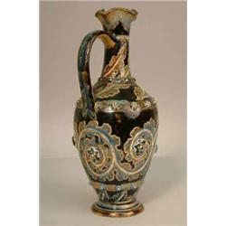 A Doulton Lambeth ewer by George Tinworth, incised with a continuous design of leaf-scrolls and a...