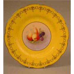 A Royal Worcester cabinet plate painted with pears and blackberries by H. Aynton, with a gilt yel...