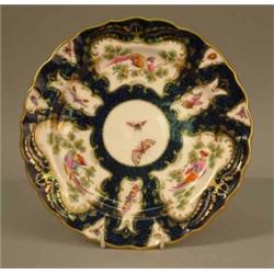 A set of 6 Royal Worcester dessert plates, decorated with panels of exotic birds against a blue s...