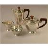 Image 1 : A silver four piece teaset with wooden handles and Celtic borders, Birmingham 1960 gross 34oz...