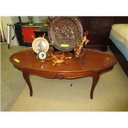Oval coffee table with carved detail in the front