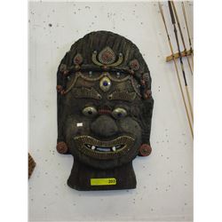 Carved wood wall mask with enamel detail