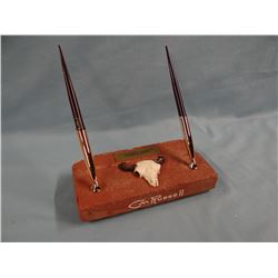 CMR desk pen set on brick salvaged in 1972 from the base of fireplace in Charlie Russell's home; wit