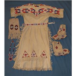 Plains Indian beaded ladies outfit including  dress, medallion necklace, moccasins, beaded bag, belt