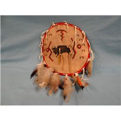 Northern Plains leather shield--buffalo, lightning, hoof prints, feathers, tourist trade, 1960's
