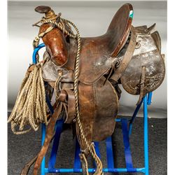 Old, Worn Saddle with Bridle and Lariat