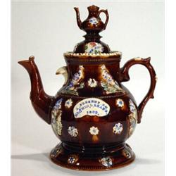 Large brown glazed bargeware teapot and cover on stand relief moulded with leaves and berries and pe