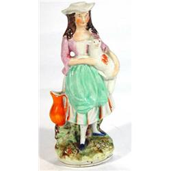 Hand painted Victorian Staffordshire figurine, a young maiden clutching a lamb, 20cm high