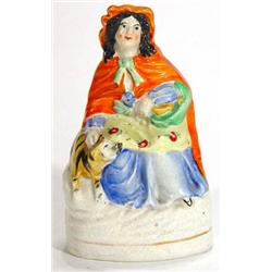 Hand painted Victorian Staffordshire figurine 'Little Red Riding Hood' beside a tiger, 14cm high