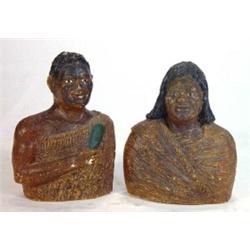 Pair of 19th century Maori busts in traditional costume carved from amber gris, 17cm high