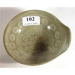 Small slate coloured oriental shallow lipped bowl with incised flowerheads, 13cm in diameter