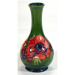 Moorcroft baluster vase hand painted and tubelined with anemones onto a dark green ground, impressed