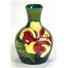 Image 1 : Small Moorcroft vase hand painted and tubelined with 'Hibiscus' pattern onto a green and blue ground