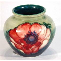 Small Moorcroft vase hand painted and tubelined with anemones onto a green and blue ground, impresse