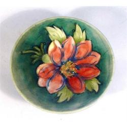 Moorcroft pedestal dish hand painted and tubelined with 'Clematis' pattern onto a light blue ground,