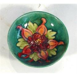 Moorcroft pedestal dish hand painted and tubelined with 'Colombine' pattern onto a light green groun