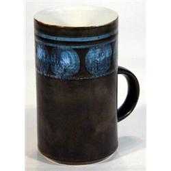 Early Troika mug hand painted with a band of blue circles and stripes onto a black ground 14cm high