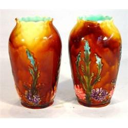 Pair of continental pottery vases, hand painted and relief moulded with flowers onto a treacle glaze