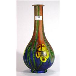 Art glass vase decorated with yellow and green flowers and foliage onto a red and blue mottled groun