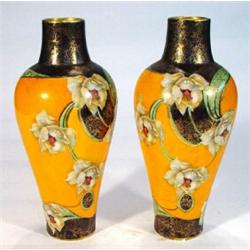 Pair of Victorian pottery vases, printed and gilded with flowers onto an orange ground, 30cm high