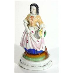 Victorian hand painted porcelain figurine of a young maiden clutching a basket of fruit, 17cm high