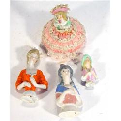 Four hand painted porcelain pinladies, largest 7cm high