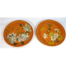 Two Watcombe terracotta plates hand painted with flowers and butterflies, impressed marks to base, 2