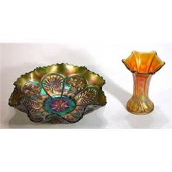 Purple and orange Carnival glass bowl with panels of peacocks, leaves and berries and a twisted oran