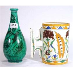 Hand painted 19th century Islamic tankard decorated with an Isnik style pattern and a turquoise glaz