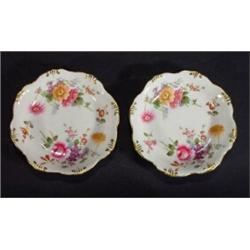 Two Royal Crown Derby circular dishes, hand painted with Derby posies, marks to base, 12cm diameter