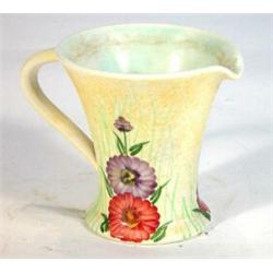 Radford pottery jug hand painted with flowers onto a mottled yellow ground, marks to base, 12cm high