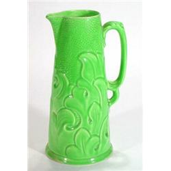 Large green glazed pottery jug, relief moulded with stylised leaves, impressed marks to base, 33cm h