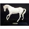 Image 1 : White glazed 'Spirit of Youth' horse on a black base, marks to base, 26cm in length