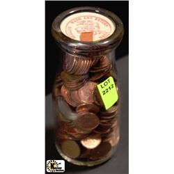CREAM JAR WITH ASSORTMENT OF PENNIES