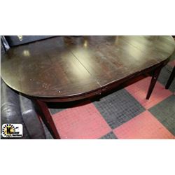 DARK WOOD OVAL SHAPE TABLE WITH SCRATCHES ON TOP