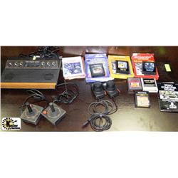 VINTAGE ATARI WITH 4 CONTROLS AND ASSORTED GAMES
