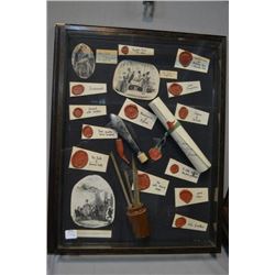 Two shadow box collages including wax seals and stamps and Charles Dickens portraits, with candlehol