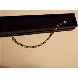 BRACELET - 12 OVAL FACETTED BLUE SAPPHIRES (6.05CTW) IN STERLING SILVER FIGURE 8 SETTING - INCLUDES 