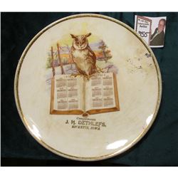 1912 Calendar Saucer "Compliments J.H. Dethlefs,/Ricketts, Iowa", Owl standing on book opened to the