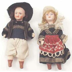 A pair of Paris Unis bisque-head miniature dolls with jointed limbs, attired in Tyrolean costume...