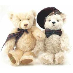 A modern Steiff white mohair teddy bear, wearing tartan hat and bow with glass eyes together with...