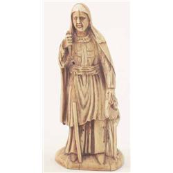 A Spanish 18th century ivory female Saint, standing in robe with cross on her bodice, staff broke...