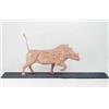 Image 1 : David Sykes: a carved wood warthog, in laminated alternating coloured woods, 16 by 22 ins. on sto...