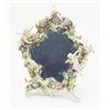 Image 1 : A late 19th century German floral encrusted porcelain dressing mirror, modelled with two cherubs...