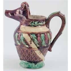 A 19th century French faience jug, with boar's head pouring lip, relief moulded with leaves and s...
