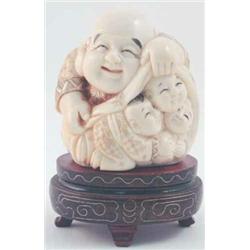 A Japanese Meiji period carved ivory okimono, carved as a portly seated man with three children,...