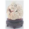 Image 1 : A Japanese Meiji period carved ivory okimono, carved as a portly seated man with three children,...