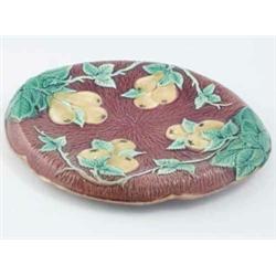 A Victorian majolica oval fruit plate, relief-moulded with pears and leaves against a brown groun...